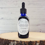 Pure Vitality herbal tincture photographed on a natural background with adaptogenic herbs.
