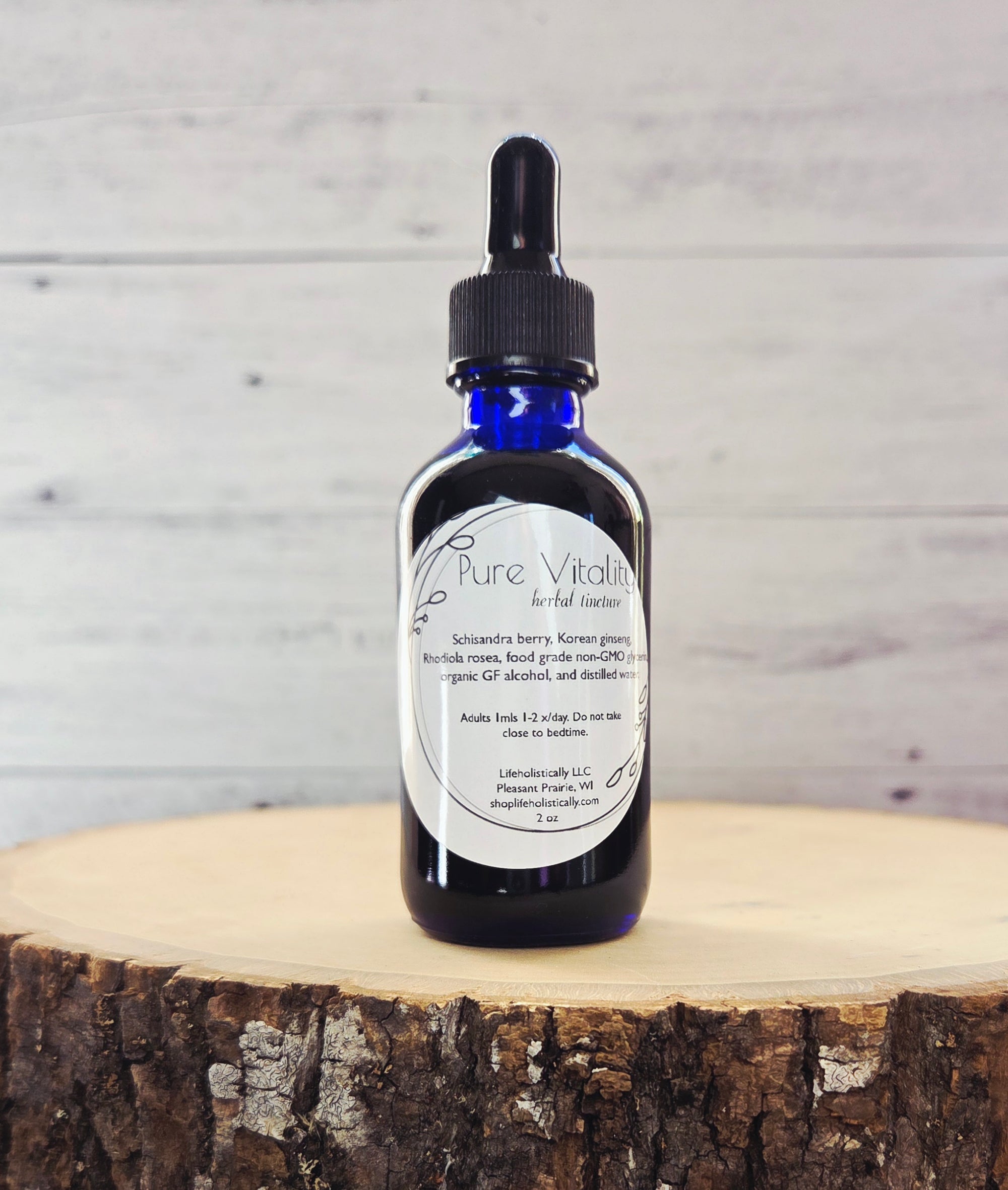 Pure Vitality herbal tincture photographed on a natural background with adaptogenic herbs.